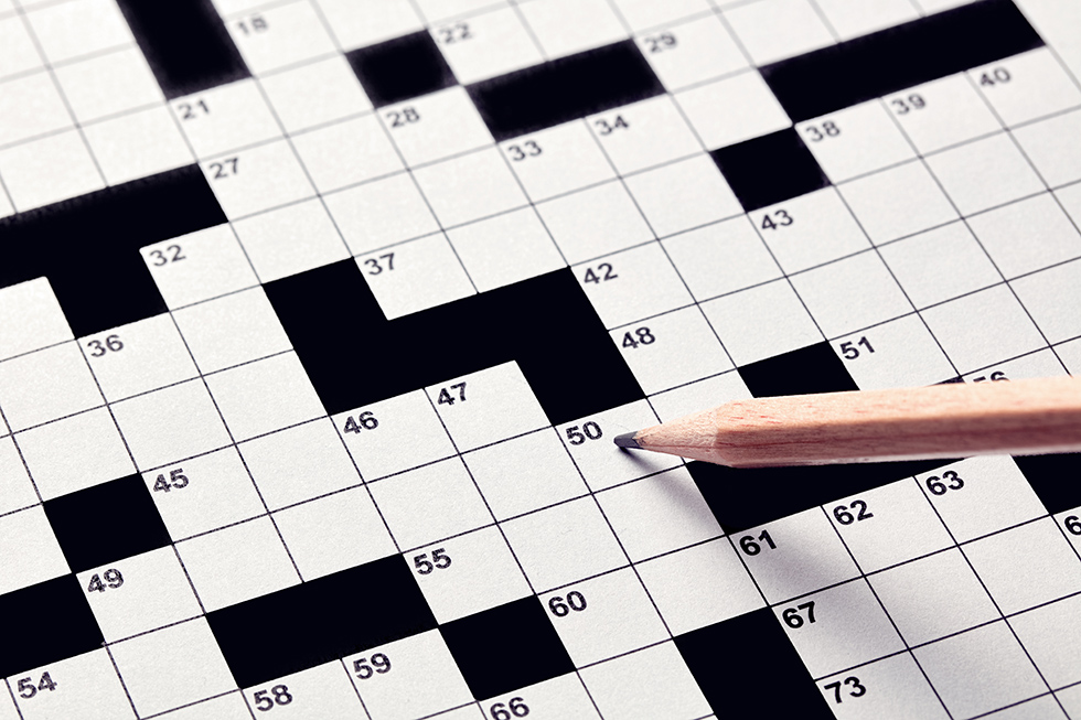 Pencil on blank crossword puzzle