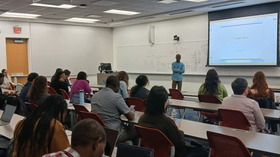 Kpogo presenting his work to an audience. 