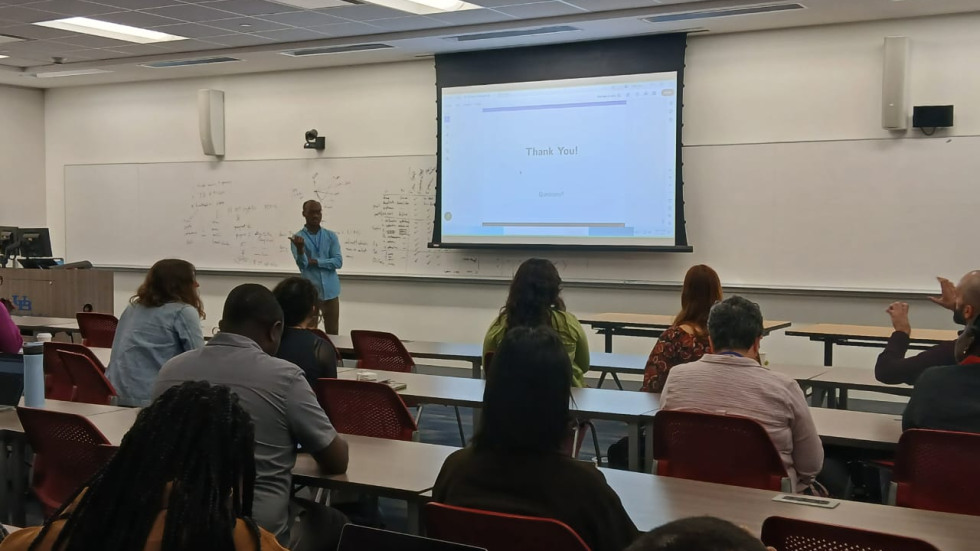 Kpogo presenting his work in front of an audience. 